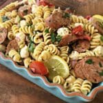 A blue dish of pasta with meat and vegetables.
