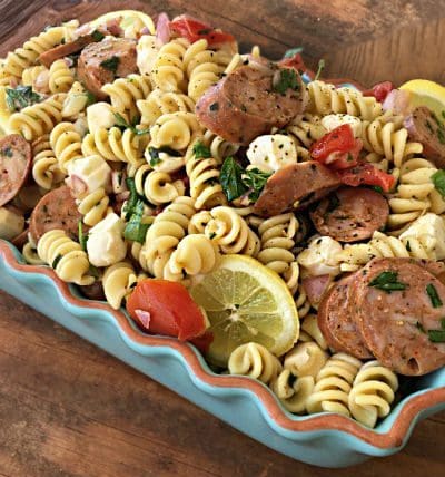 A blue dish of pasta with meat and vegetables.